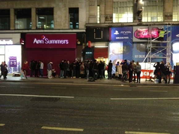 A photo of the Playstation Vita's launch at GAME's Oxford Street branch. A man is putting an extra GAME sign over the store's existing sign.